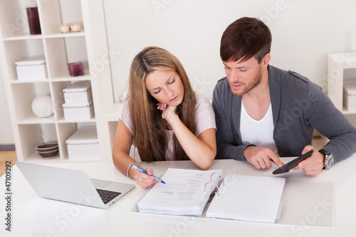 Photo: Unhappy young couple in financial trouble Unhappy young couple in financial trouble