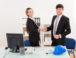 Architects shaking hands in the office