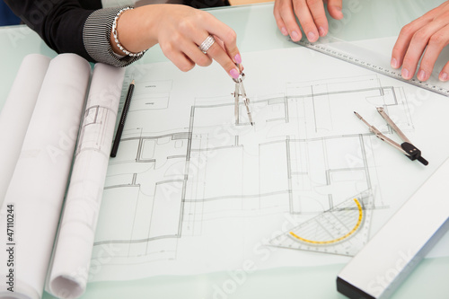 Photo: Architects discussing blueprints Architects discussing blueprints