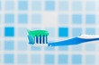 toothbrush against blue tile background