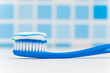 toothbrush against blue tile background
