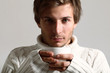 Handsome man in sweater drinking tea