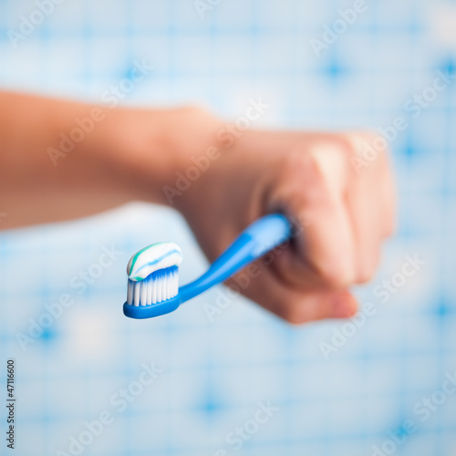 Photo: toothbrush in hand toothbrush in hand