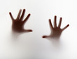 Photo: handsl silhouette behind a transparent paper handsl silhouette behind a transparent paper