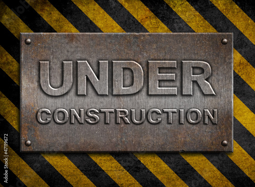 Illustration: "under construction" metal plate over hazard stripes "under construction" metal plate over hazard stripes