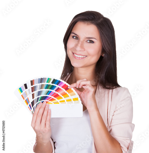 Photo: Attractive woman chooses a color scheme Attractive woman chooses a color scheme