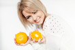 beautiful young and healthy women with yellow tangerines