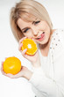 beautiful young and healthy women with yellow tangerines