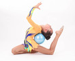 Photo: Beautiful flexible girl gymnast over white background Beautiful flexible girl gymnast over white background