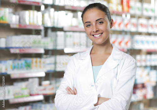 Photo: Portrait of Smiling Woman Pharmacist in Pharmacy Portrait of Smiling Woman Pharmacist in Pharmacy