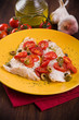 Fish with cherry tomatoes and olive.