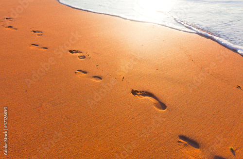 Photo: beach, wave and footsteps at sunset time beach, wave and footsteps at sunset time