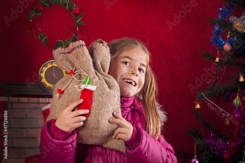 Photo: happy child with Christmas gift happy child with Christmas gift
