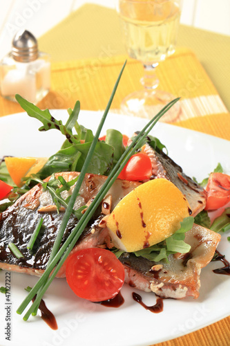 Photo: Salmon trout fillets and salad greens Salmon trout fillets and salad greens