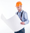 Photo: Male architect looking at blueprints against white background Male architect looking at blueprints against white background