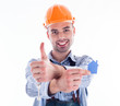 Photo: A builder man holding a key and a paper house. A builder man holding a key and a paper house.