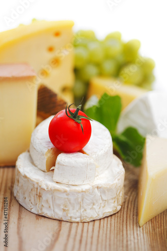 Photo: cheese on a wooden table cheese on a wooden table
