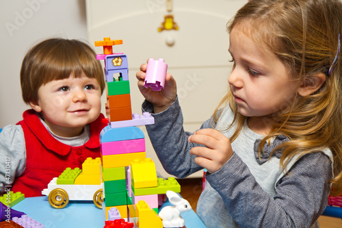Photo: Little girls playing with building bricks Little girls playing with building bricks