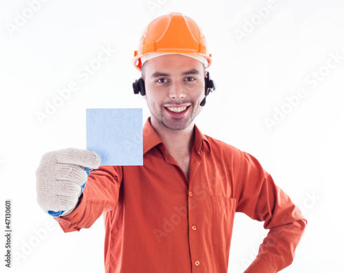 Photo: A builder man holding sheet of paper. A builder man holding sheet of paper.