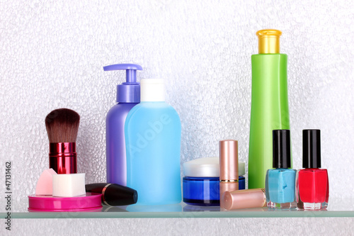 Photo: Shelf with cosmetics and toiletries in bathroom Shelf with cosmetics and toiletries in bathroom