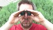 Man Looking through Binoculars