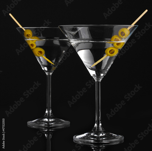 Photo: Martini glasses and olives isolated on black Martini glasses and olives isolated on black