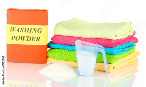 Photo: Box of washing powder with blue measuring cup and towels, Box of washing powder with blue measuring cup and towels,