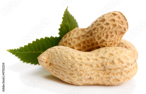 Photo: tasty peanuts with leaves, isolated on white tasty peanuts with leaves, isolated on white