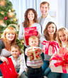 Photo: Happy Big Family with Christmas Gifts at Home Happy Big Family with Christmas Gifts at Home