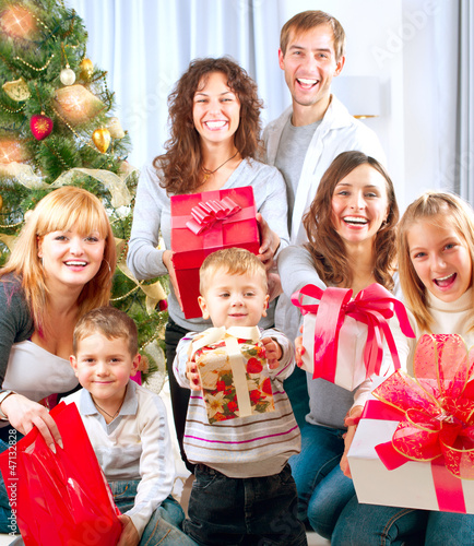 Photo: Happy Big Family with Christmas Gifts at Home Happy Big Family with Christmas Gifts at Home