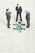 Businessmen figurines discussing about empty jigsaw puzzle space