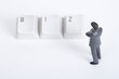 Photo: Businessman figurine standing and looking at keyboard keys Businessman figurine standing and looking at keyboard keys