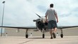 Man Spins Propeller on Airplane