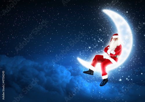Photo: photo of santa claus sitting on the moon photo of santa claus sitting on the moon
