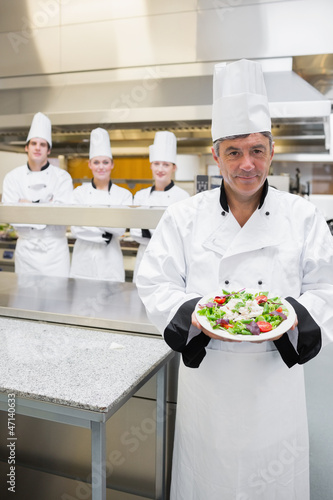Photo: Head chef showing a salad Head chef showing a salad
