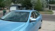 Old Lady Driving Car into Driveway