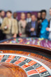 People standing looking at the roulette wheel
