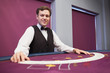 Smiling dealer with spread deck of cards