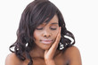 Woman touching her face