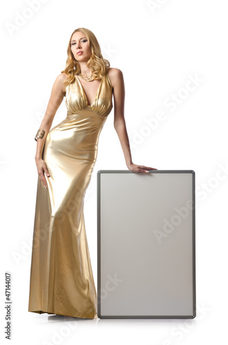 Photo: Woman in golden dress with blank board Woman in golden dress with blank board