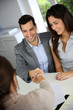 Photo: Young couple signing financial contract Young couple signing financial contract