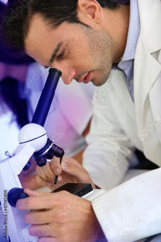 Photo: Doctor in biology working on microscope Doctor in biology working on microscope