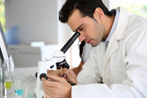 Photo: Doctor in biology working on microscope Doctor in biology working on microscope