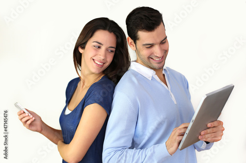 Photo: Couple websurfing on internet with new technologies Couple websurfing on internet with new technologies