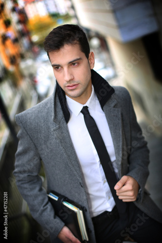 Photo: Trendy active man walking in town Trendy active man walking in town