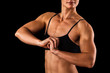 Photo: muscular female body against black background. muscular female body against black background.