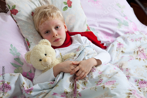 Photo: Sick boy lies in bed Sick boy lies in bed