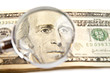 dollars and magnifying glass