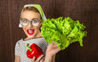 Funny woman cook holding salad and sweet pepper