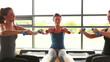 Women group lifting weights on exercise ball
